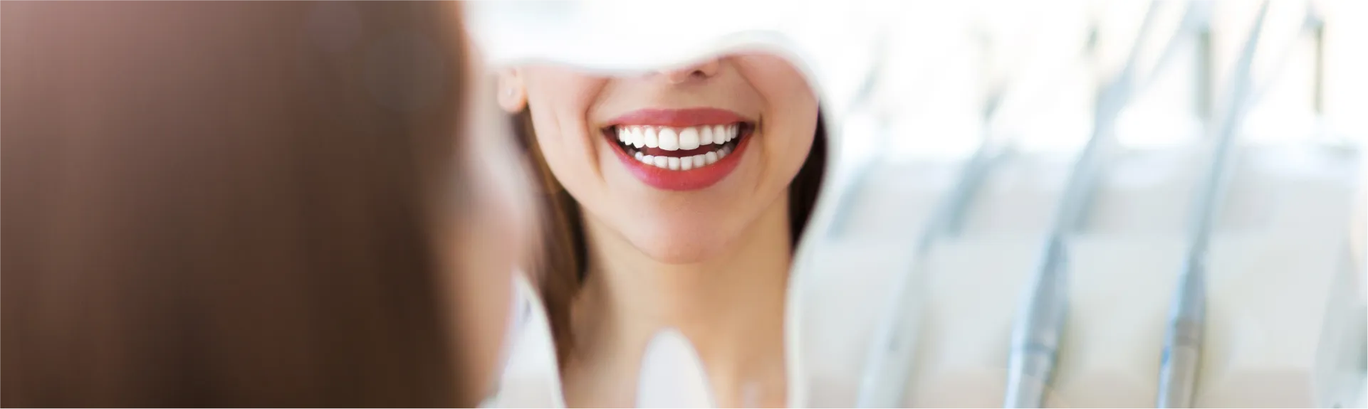 Girl looking a smile in the mirror